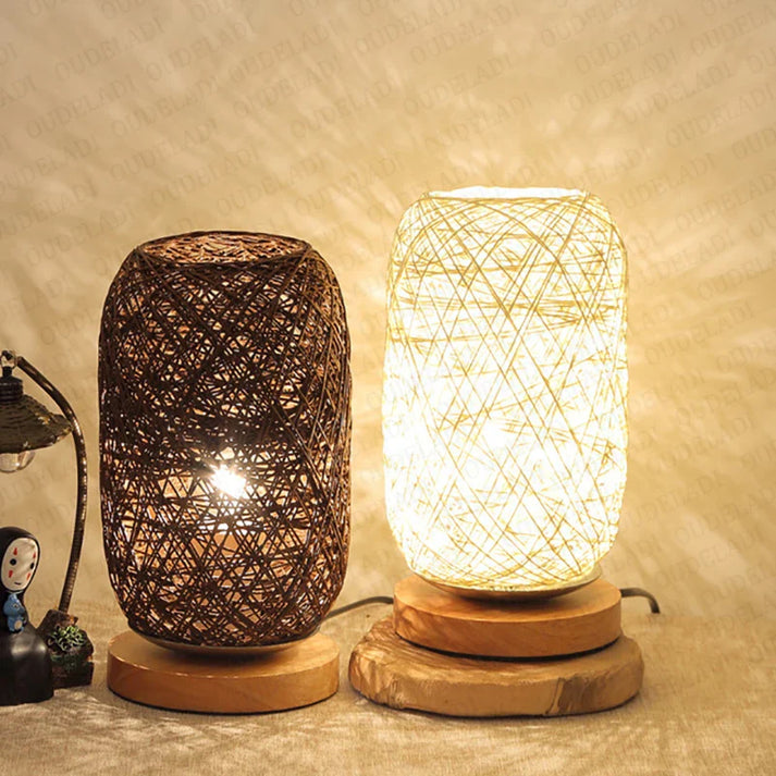 Two woven table lamps on a textured surface with a warm glow.