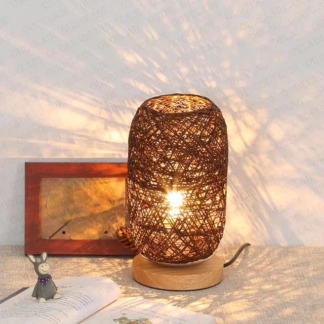 Woven rattan table lamp on a surface with a soft light background