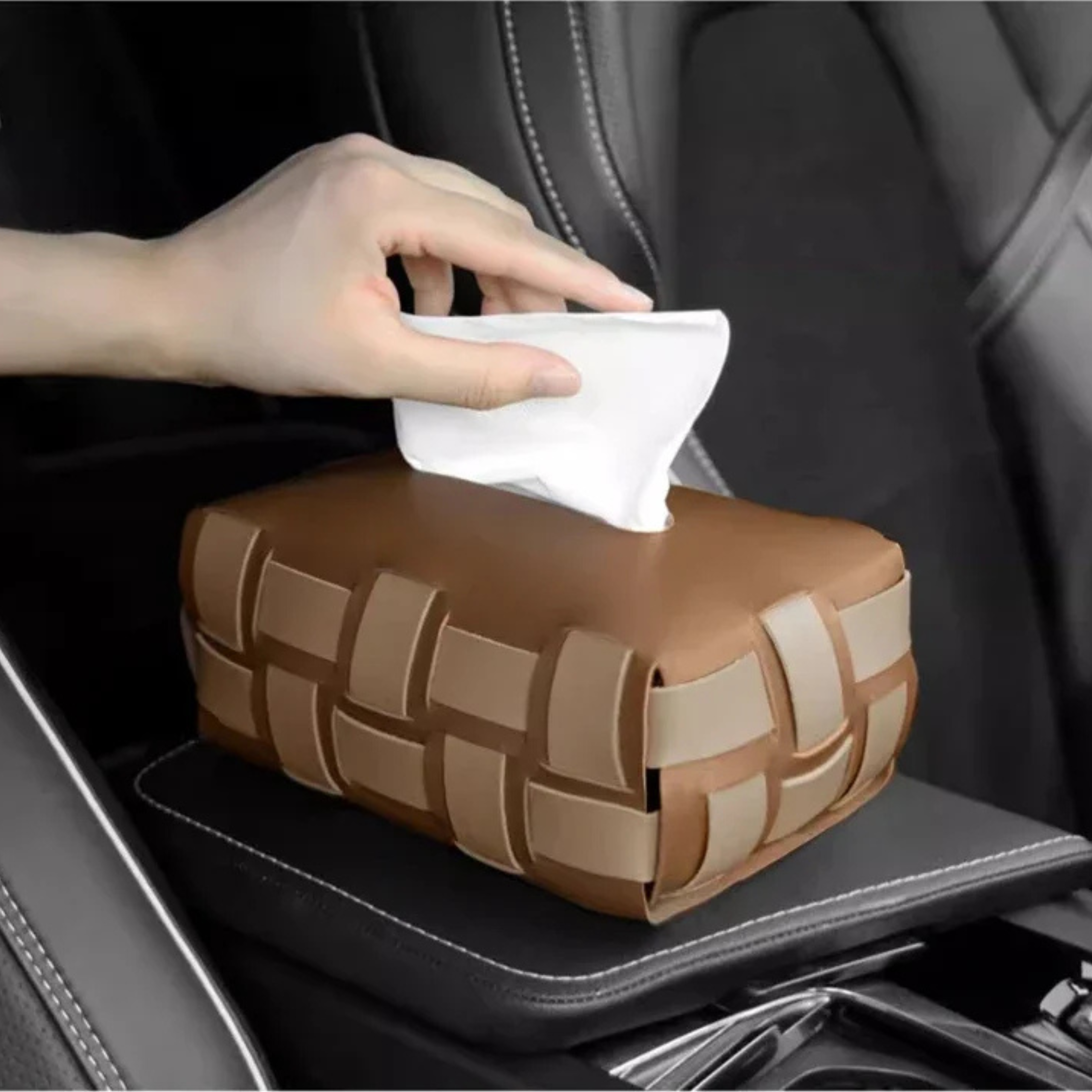 Brown woven car tissue holder with a hand reaching for tissues inside a car.