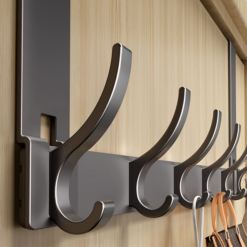 Set of black wall hooks on a wooden panel