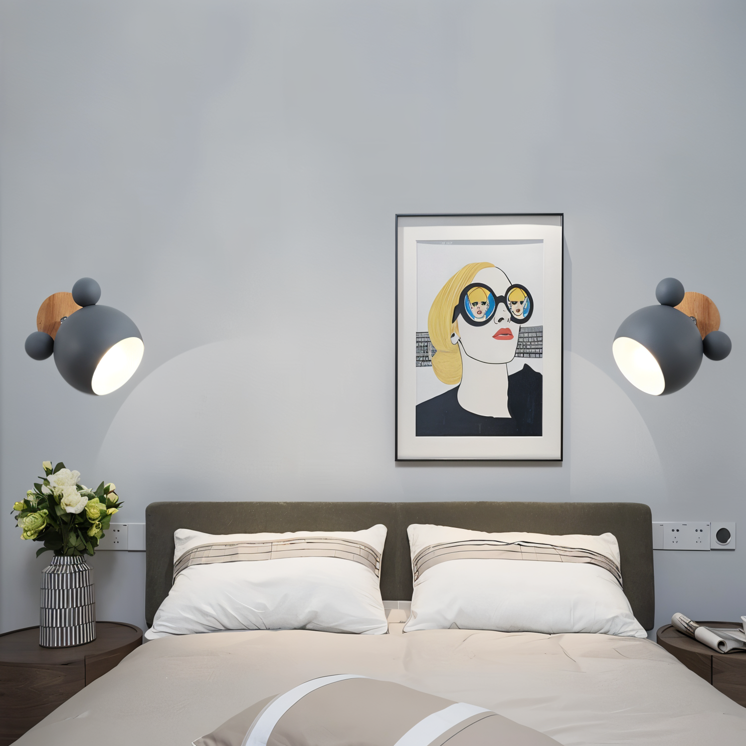 Modern bedroom with a bed, wall art, and decorative lights.