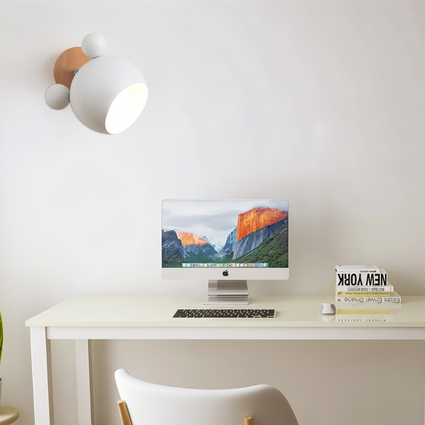 Modern home office setup with a computer on a desk, wall light fixture, and decorative box.