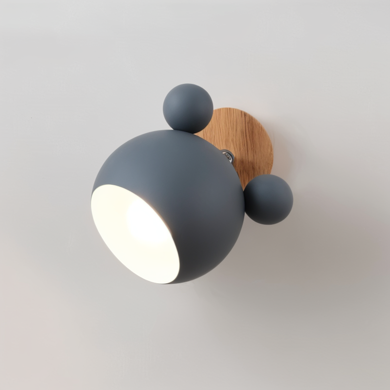 Modern wall light fixture with two spherical shades on a plain background