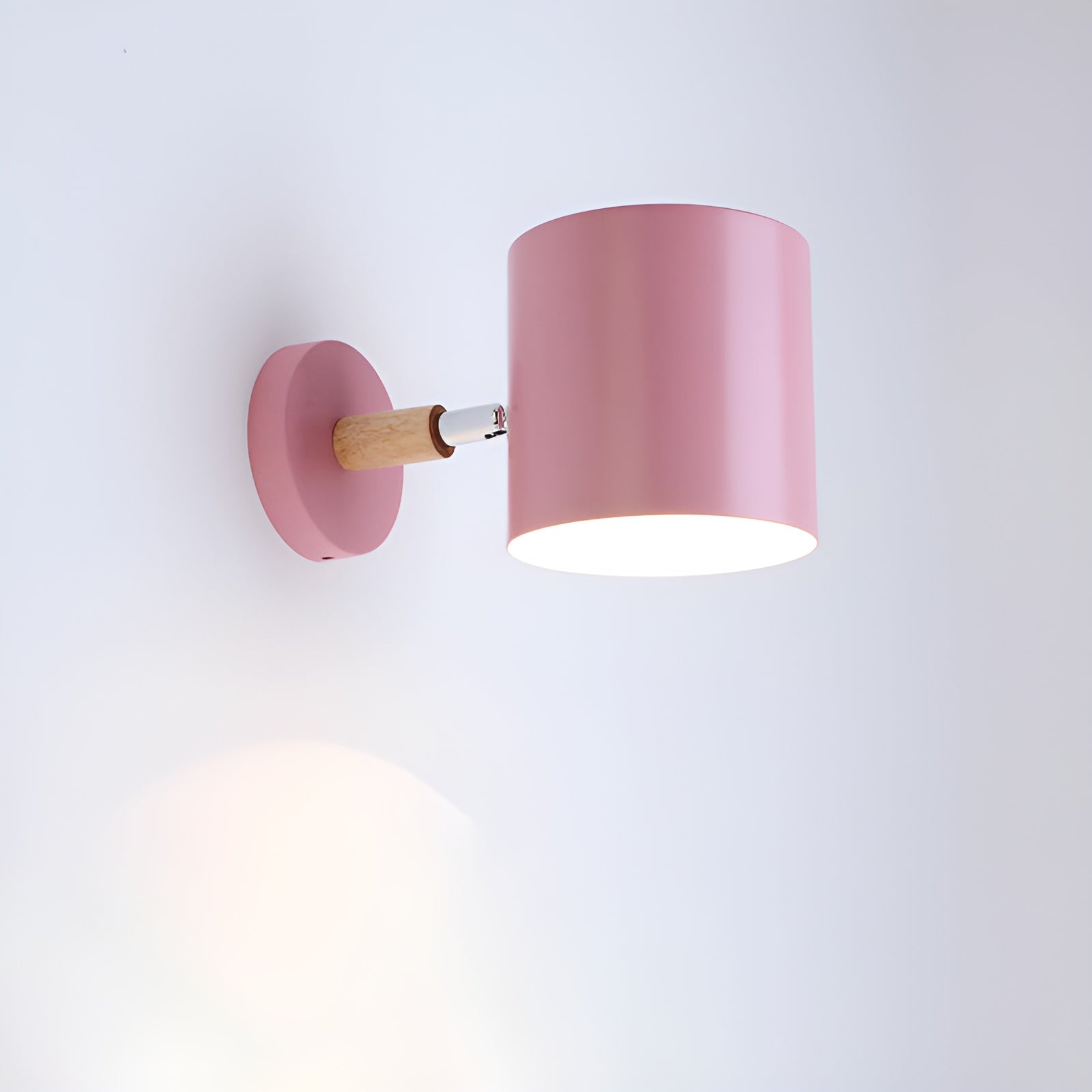 Pink wall lamp with wooden fixture on a white background