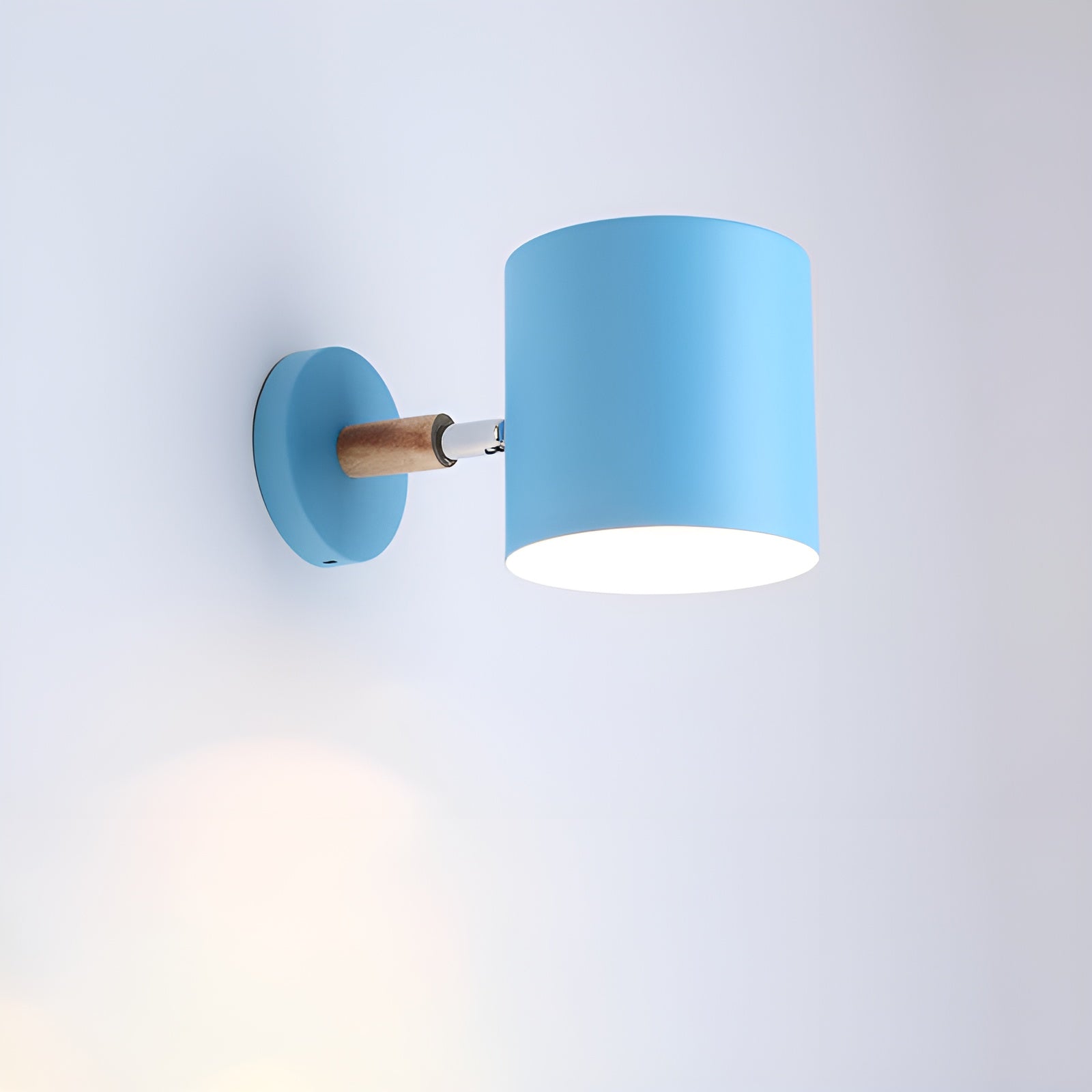 Blue wall lamp with wooden accent on a light gray background