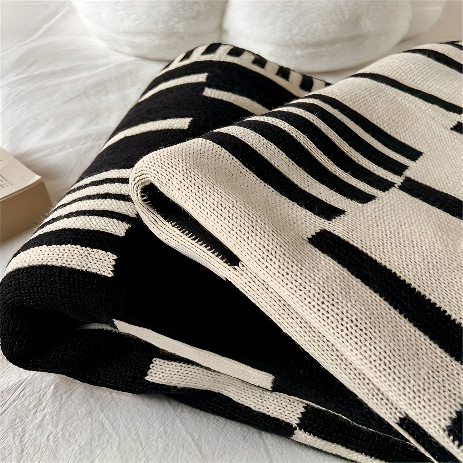 Black and white striped blanket on a white surface
