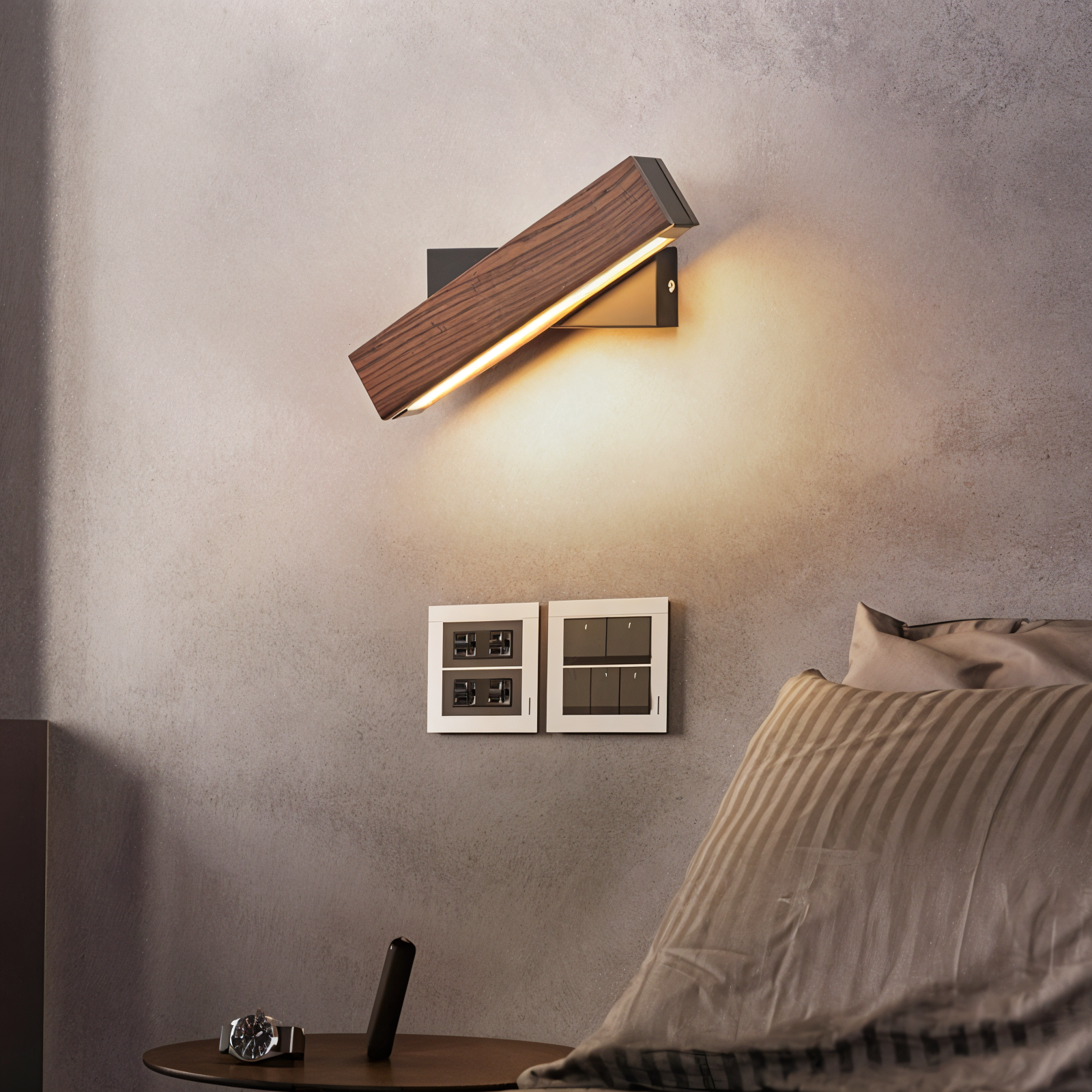 Modern wall sconce lighting fixture on a textured wall with a cozy room setting.