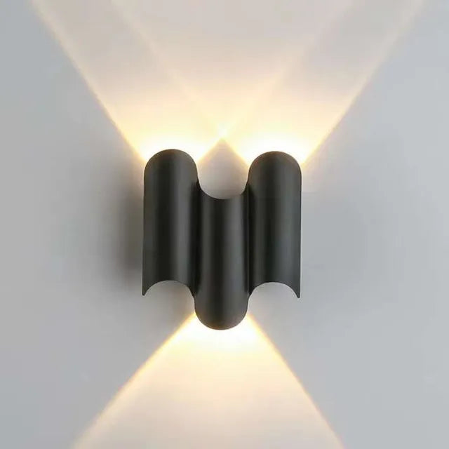 Modern black wall light fixture on a white wall