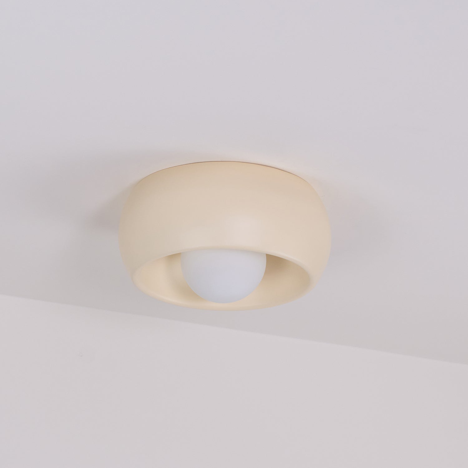 Beige ceiling light fixture on a plain white background