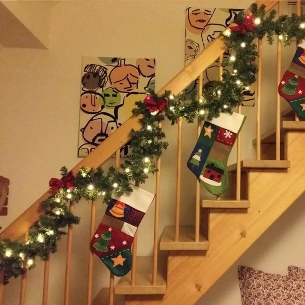 Decorative Christmas stockings hanging on a staircase with garland and lights.