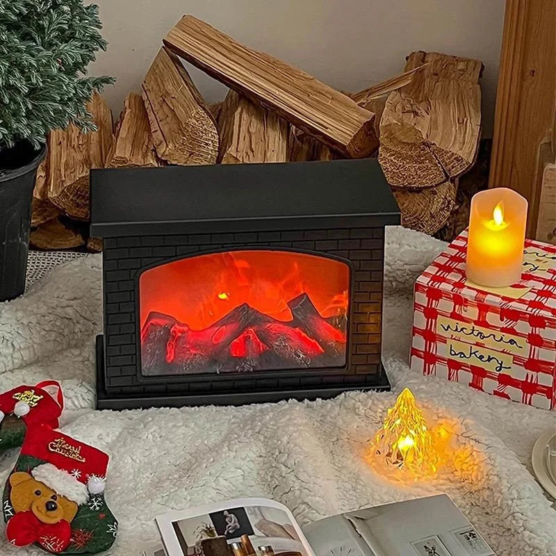 Small electric fireplace with glowing logs, surrounded by Christmas decorations and a candle.