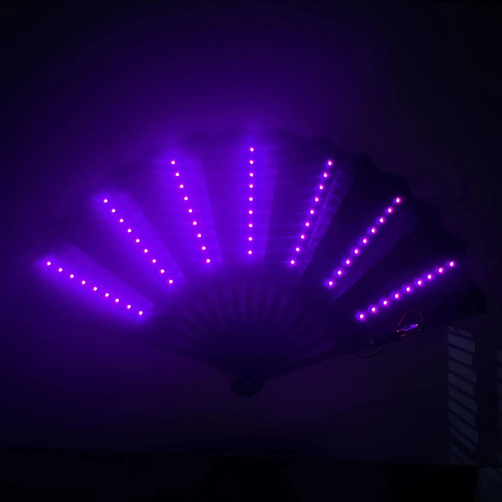 LED fan with purple light on a dark background