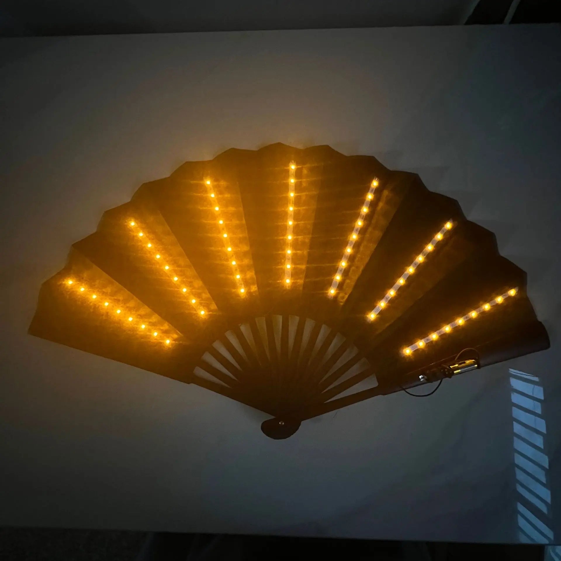 Decorative fan with LED lights on a white background