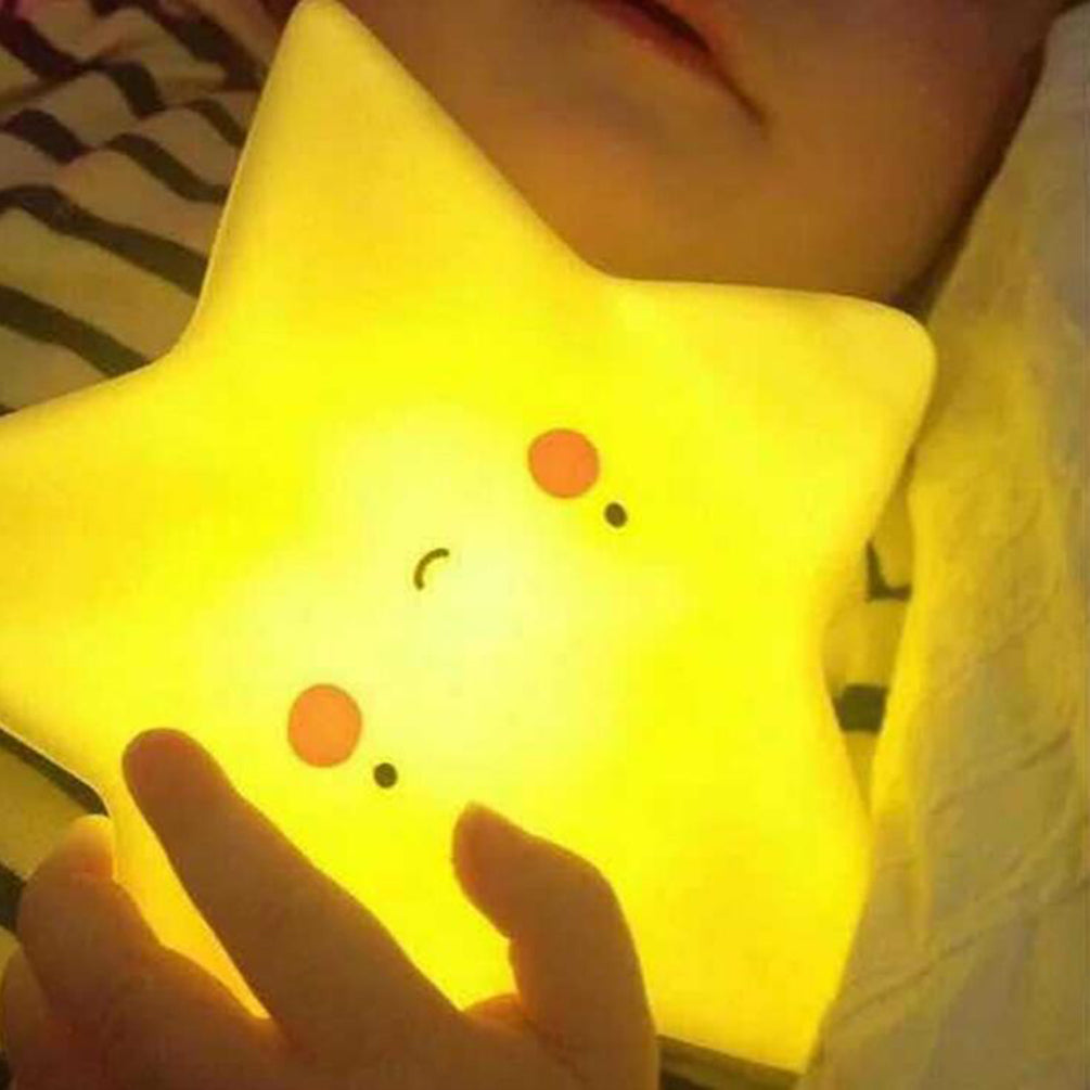 Star-shaped light with a smiley face held by a person