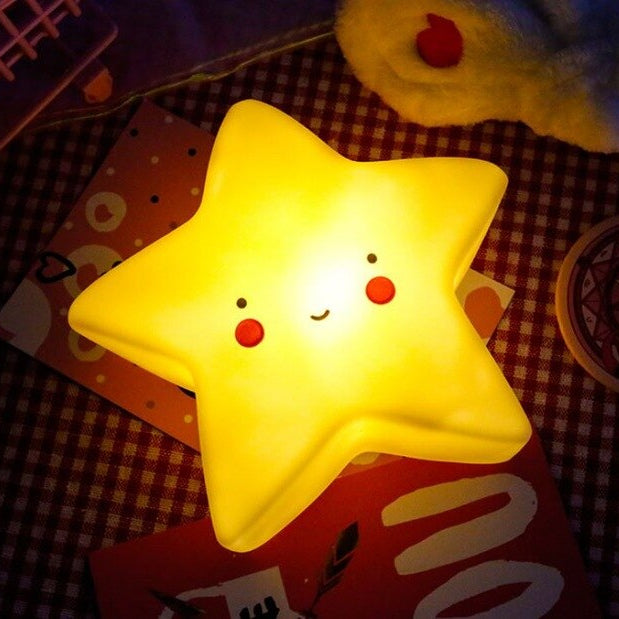 Star-shaped night light with a face on a checkered surface