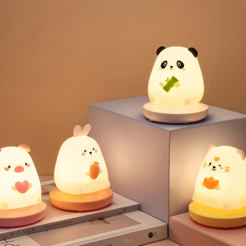 Cute animal-themed night lights on a neutral background