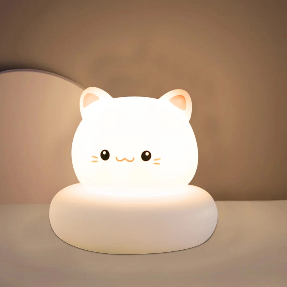 Cute cat-shaped night light on a plain background
