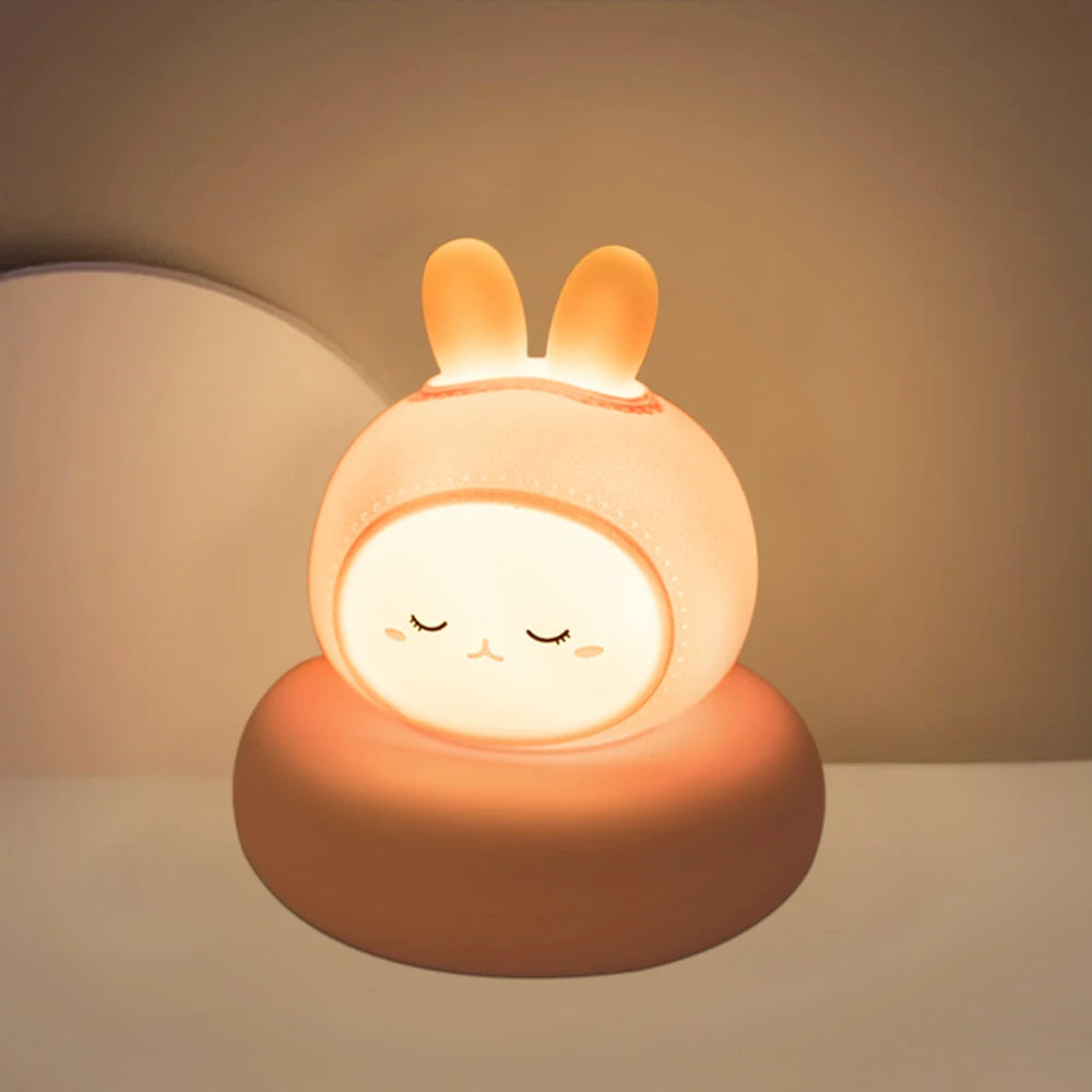 Cute rabbit-shaped night light emitting a warm glow on a neutral background