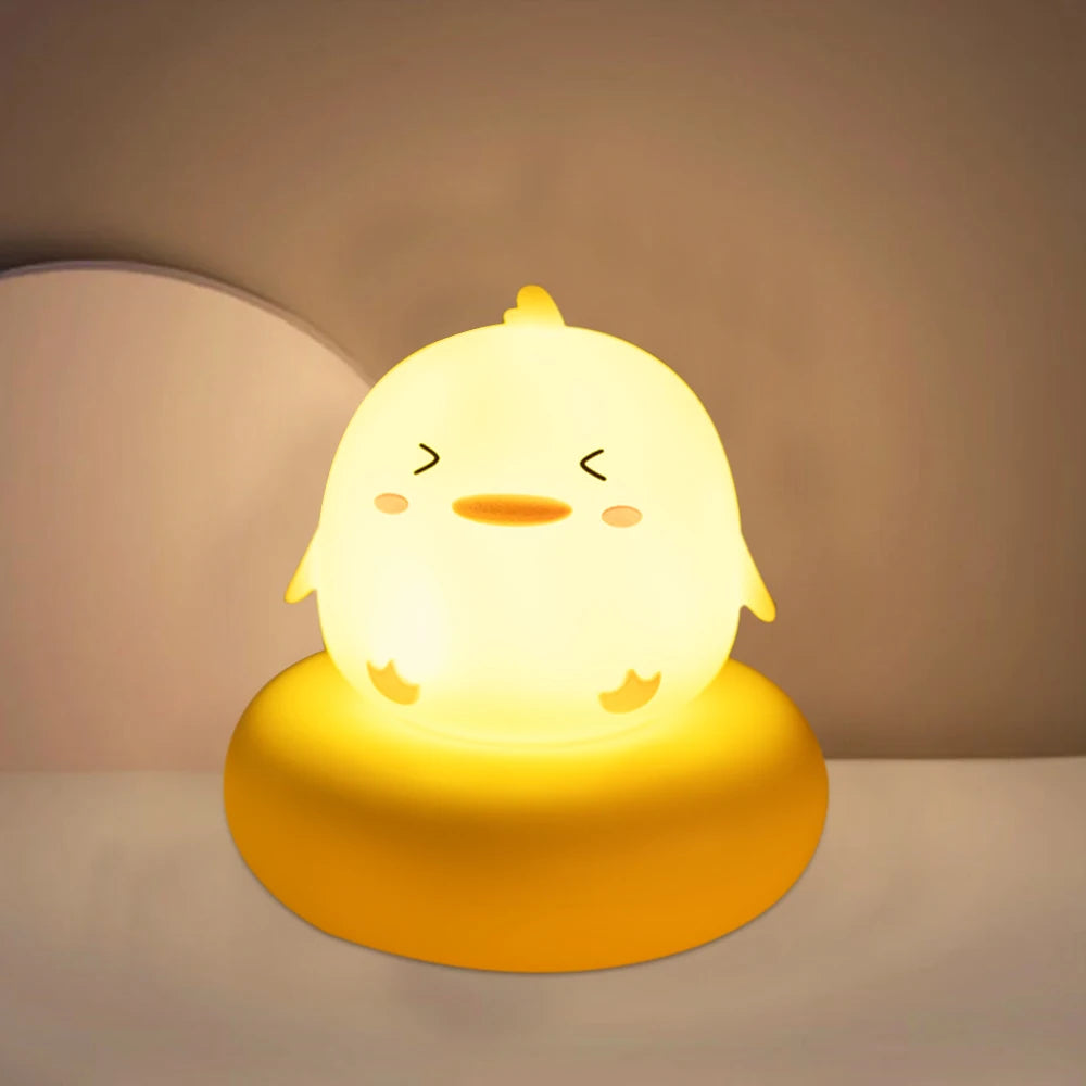 Cute chick-shaped night light on a plain background