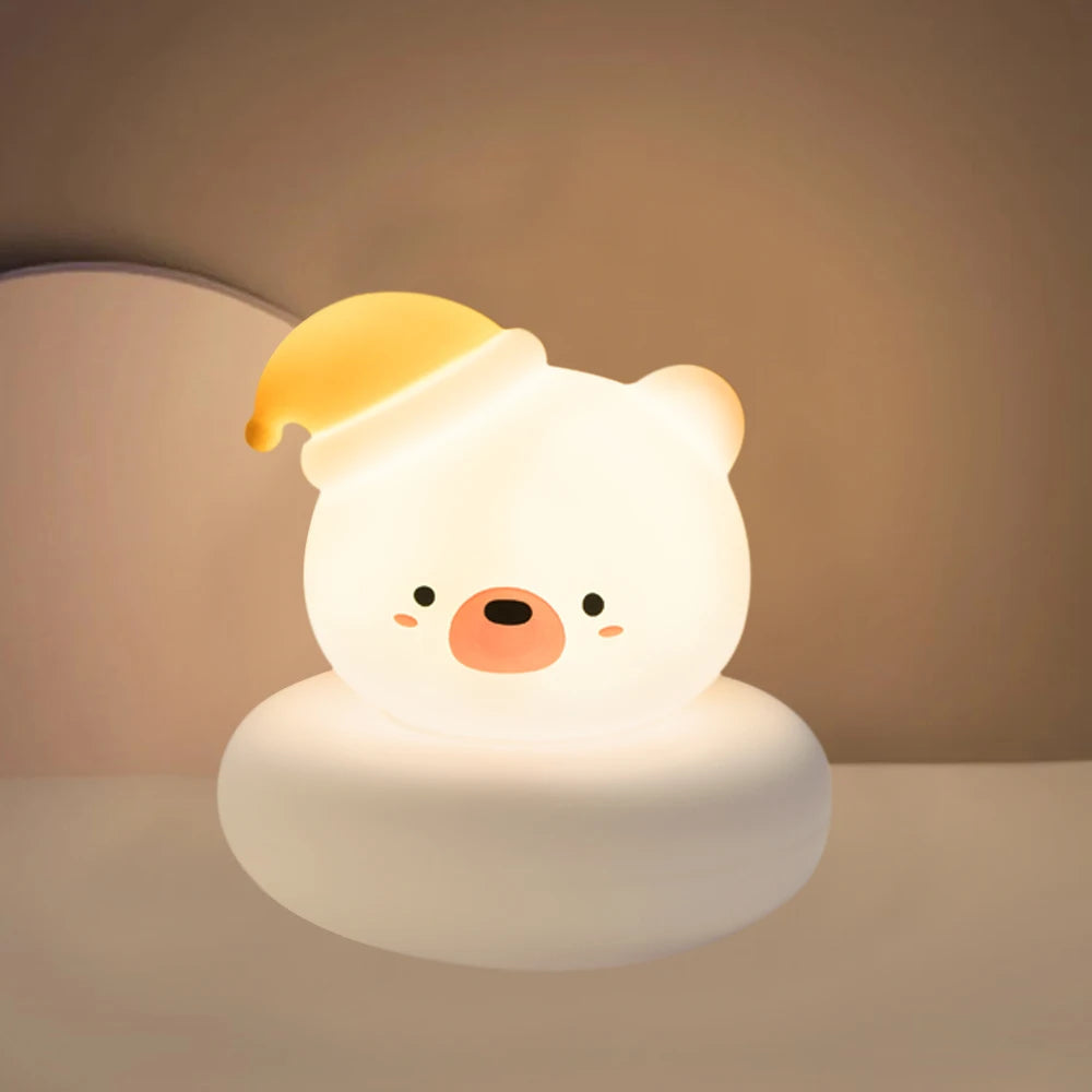 Cute animal-shaped night light with a yellow hat on a neutral background