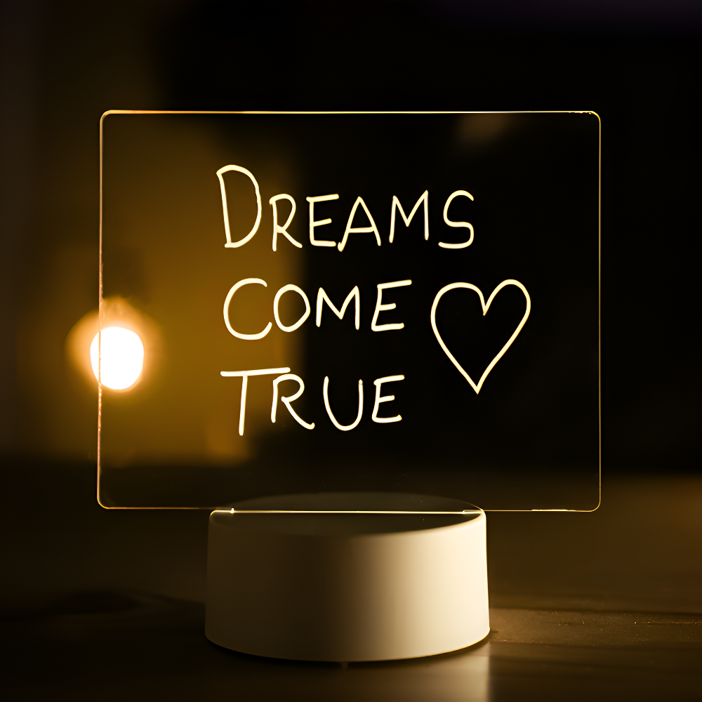 LED sign with 'Dreams Come True' text on a dark background