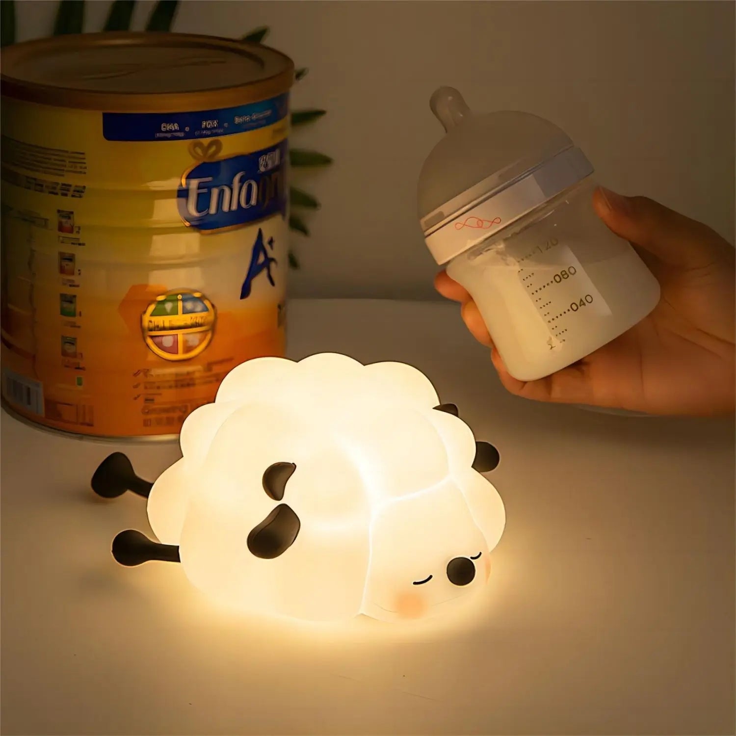 Sheep-shaped night light with Enfa baby formula can and bottle in the background