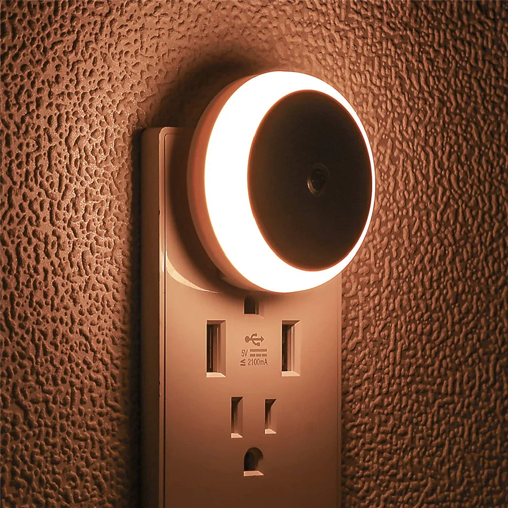 Night light attached to a wall socket on a textured brown wall