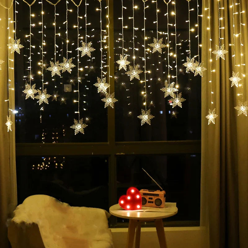 Decorative string lights with snowflake designs on a window at night.