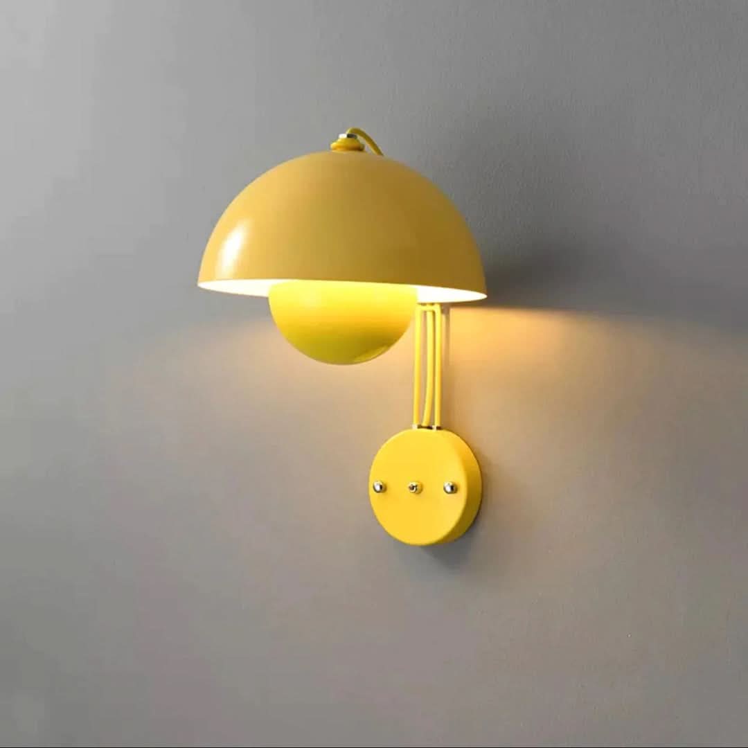 Yellow wall lamp on a gray wall
