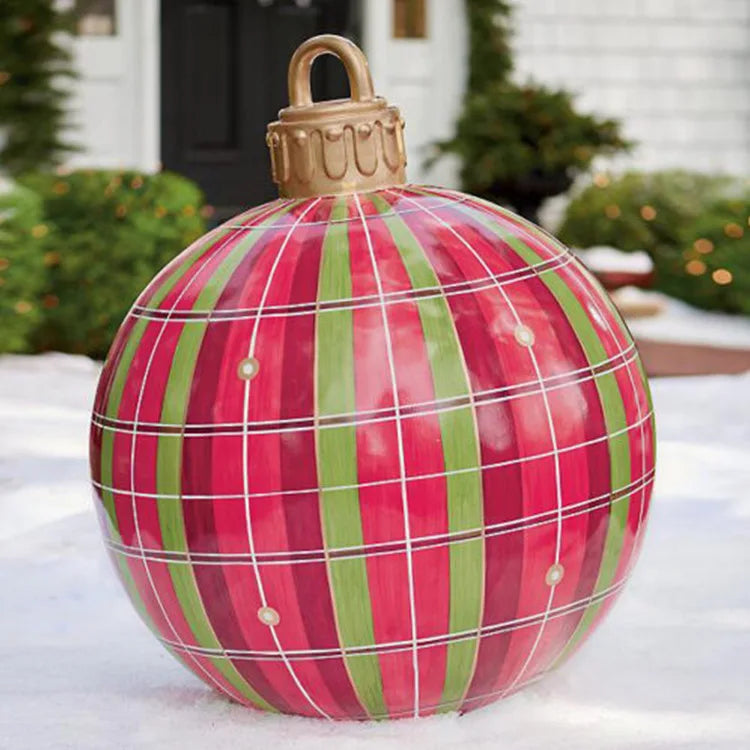 Large plaid Christmas ornament on a snowy surface