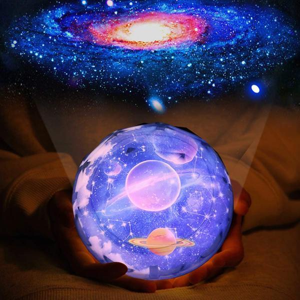 Holding a glowing crystal ball with space-themed design, showing a galaxy image in the background.