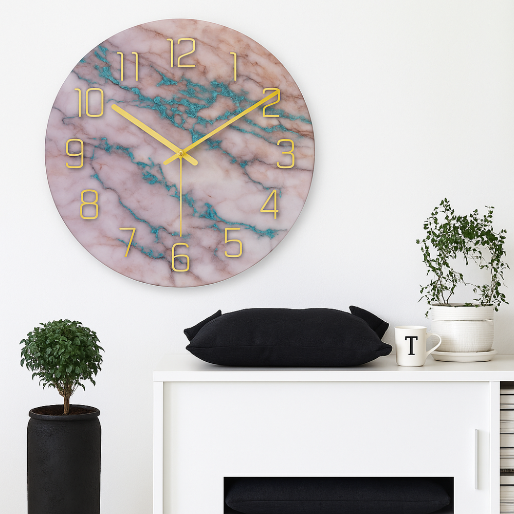 Marble-patterned wall clock with gold hands on a white wall above a white cabinet with decorative items.