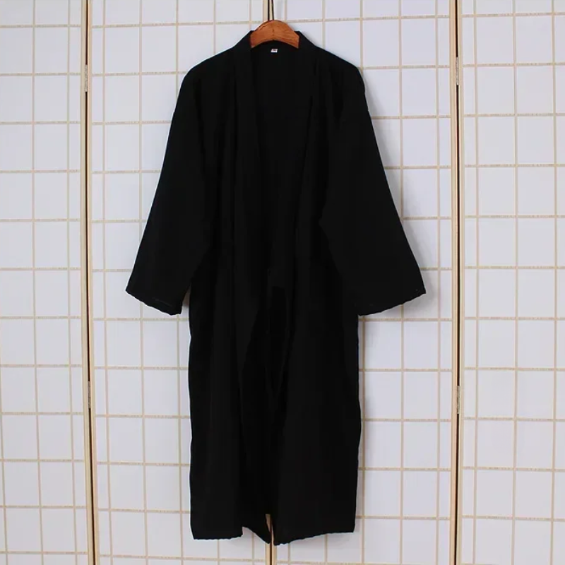 Black robe on a hanger against a tiled wall background