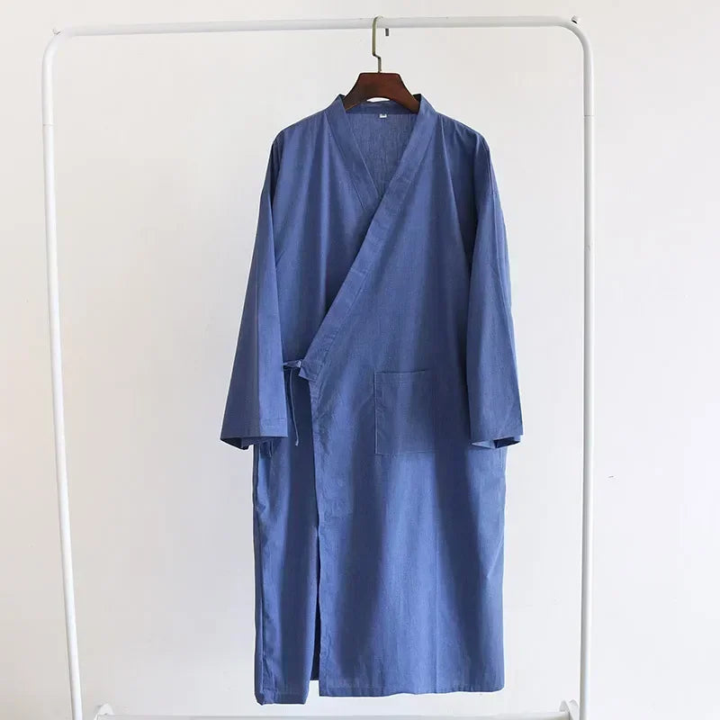Blue robe on a hanger against a white background