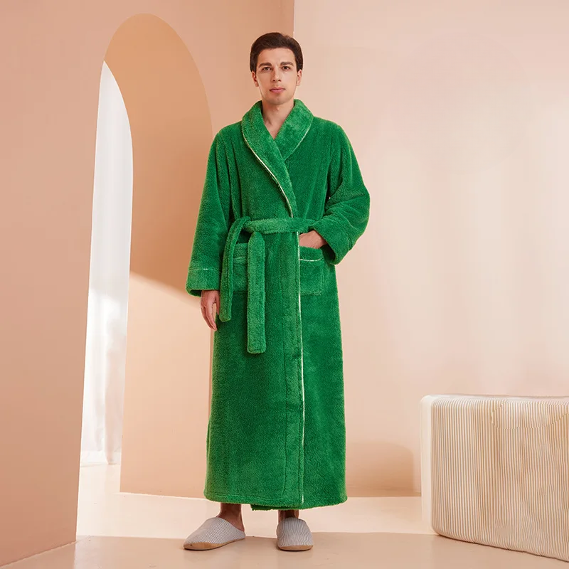 Person wearing a green bathrobe in a room with beige walls and a white rug.