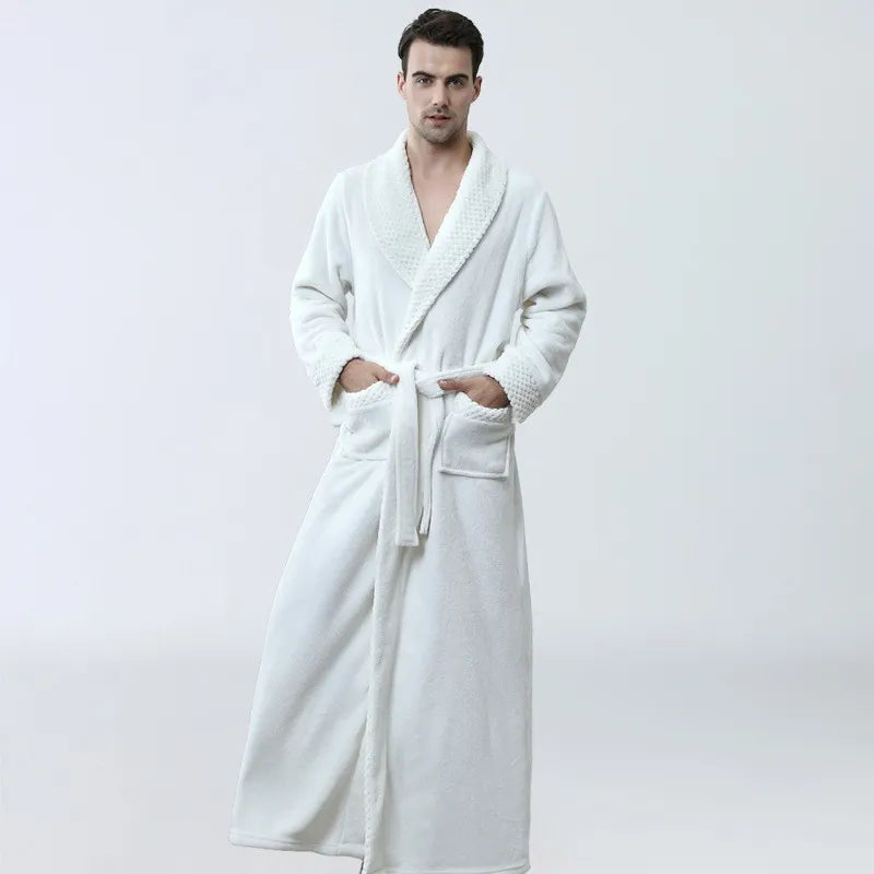 Man wearing a white robe against a plain background