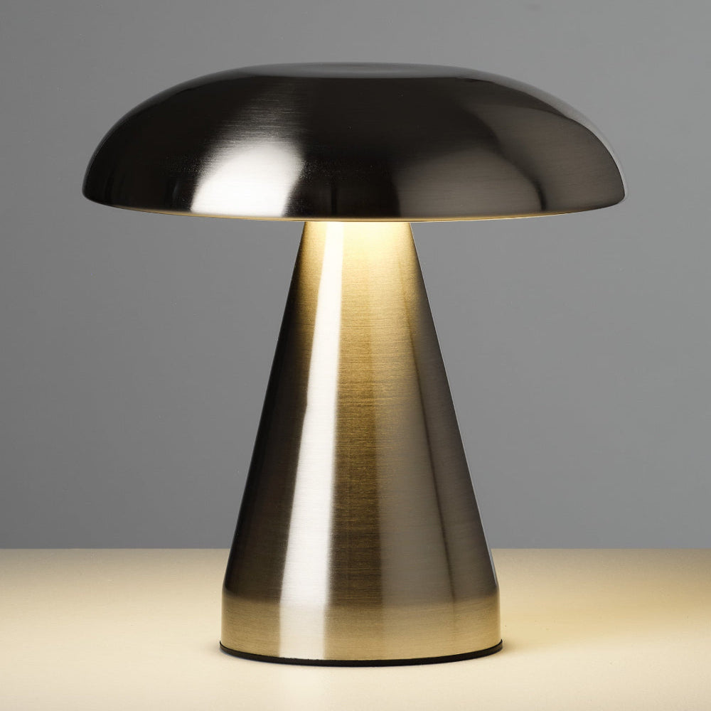 Modern table lamp with metallic base and black shade on a neutral background
