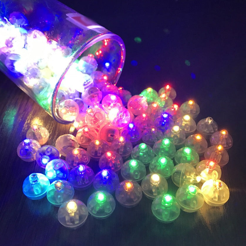 Colorful LED bubble lights spilling out of a container on a dark background