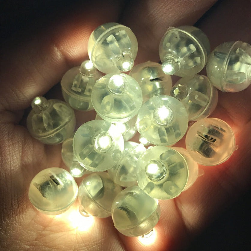 Clear plastic buttons with LED lights held in a hand