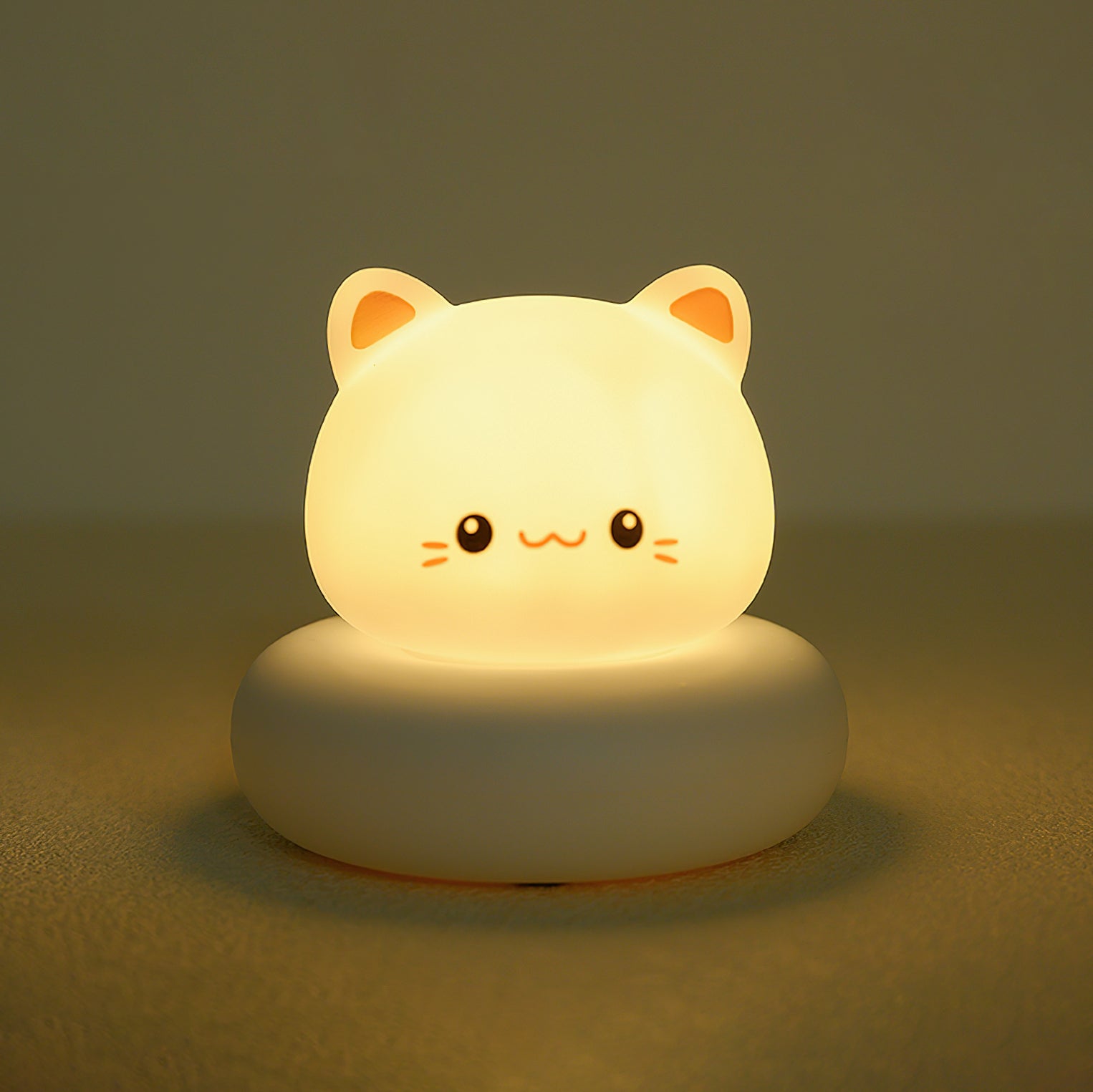 Cute cat-shaped night light on a dark background