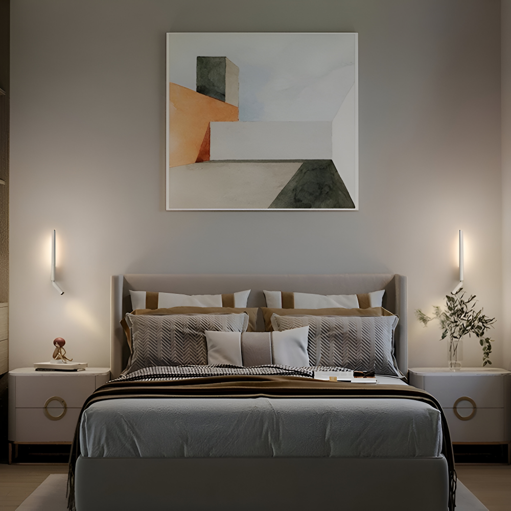 Modern bedroom with a bed, abstract art on the wall, and side tables.
