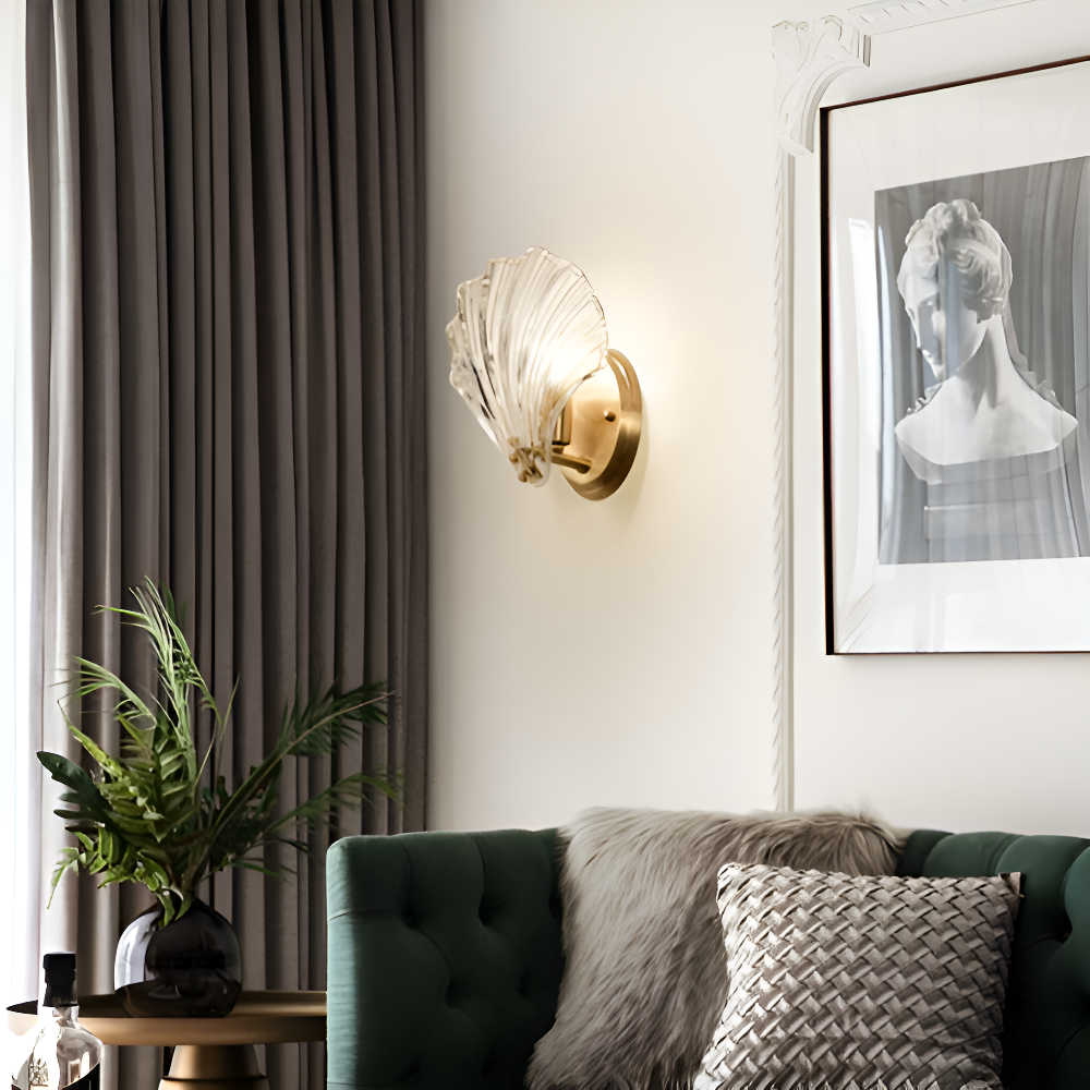 Modern living room with a green sofa, decorative wall light, and framed artwork.