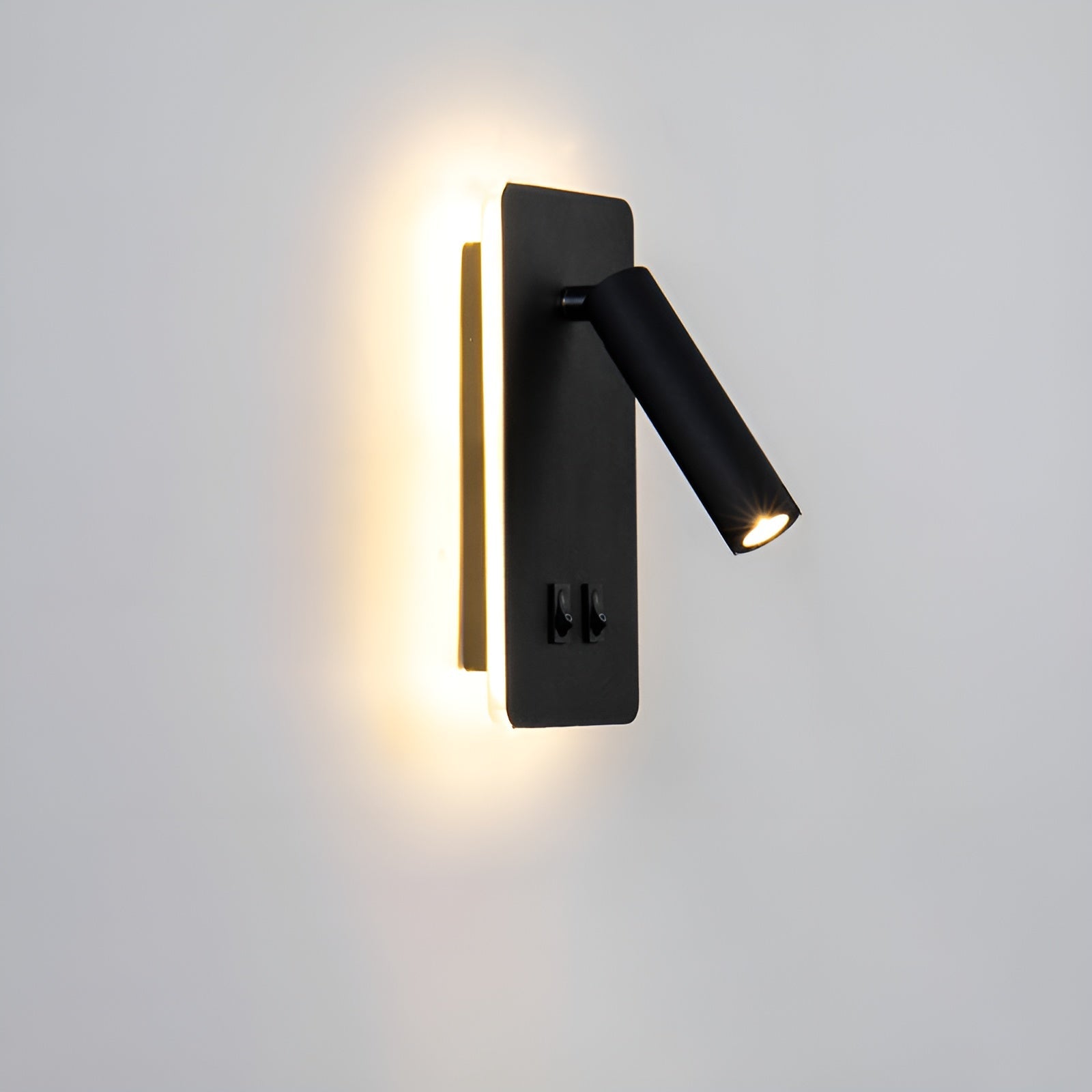Modern black wall-mounted light fixture on a white wall