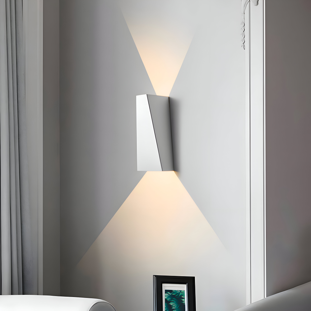 Modern wall-mounted light fixture on a gray wall with a curtain in the background