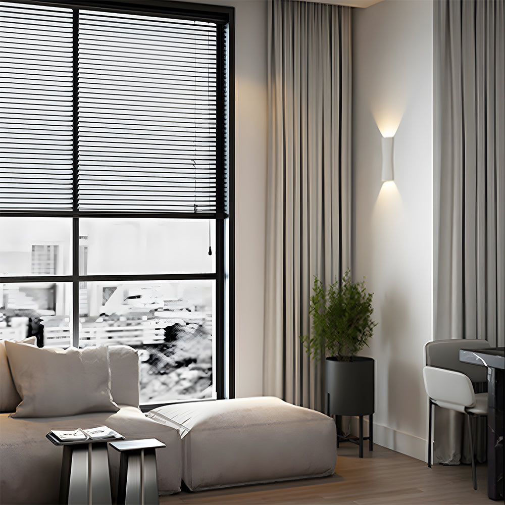 Modern living room with large window, white sofa, and cityscape view.