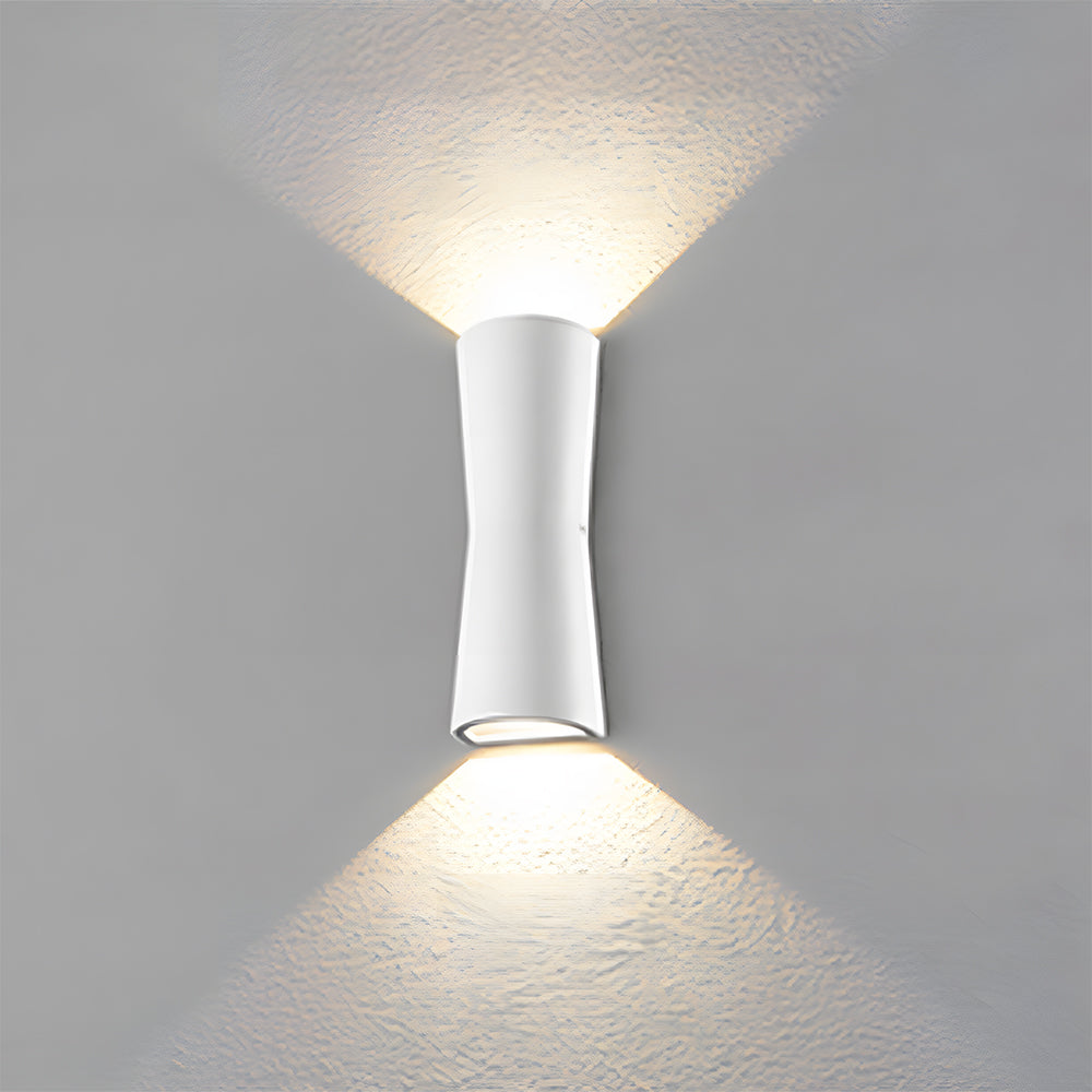 White wall-mounted light fixture on a gray textured wall