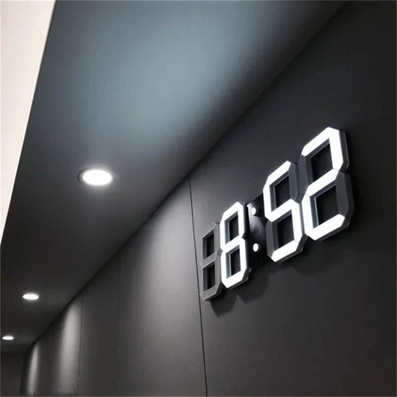 Digital clock displaying the time on a dark wall.