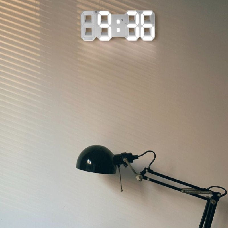 Black lamp with a wall-mounted digital clock displaying the time.