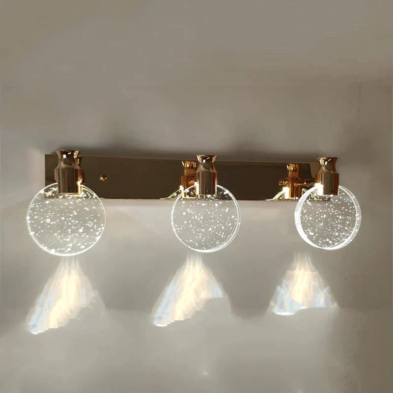 Modern wall-mounted light fixture with three circular lights on a neutral background