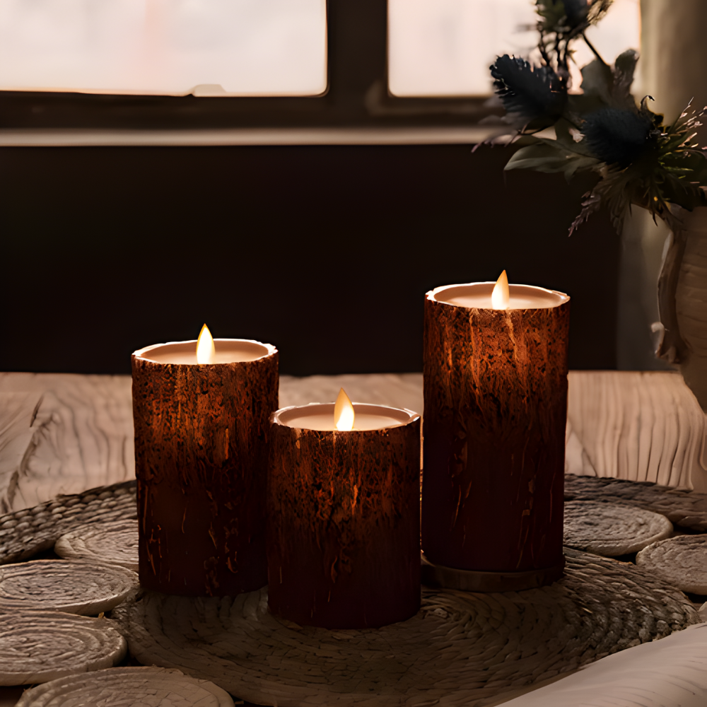 Three wooden-textured candles on a textured surface with a blurred indoor background